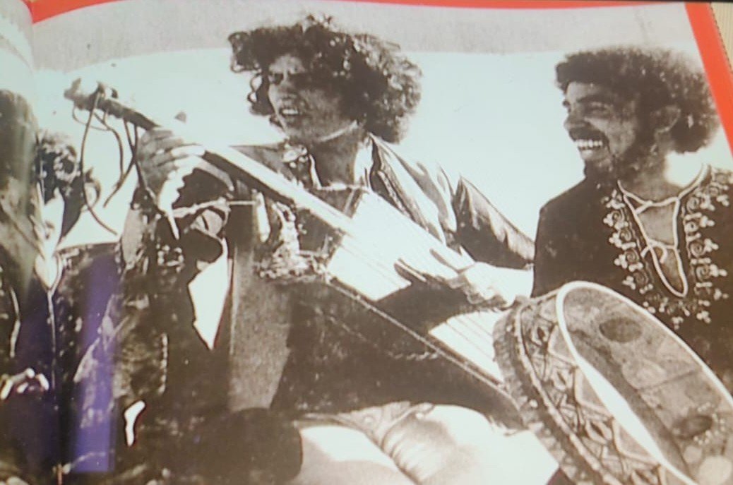 Two band members performing with a fretless banjo, 1970s