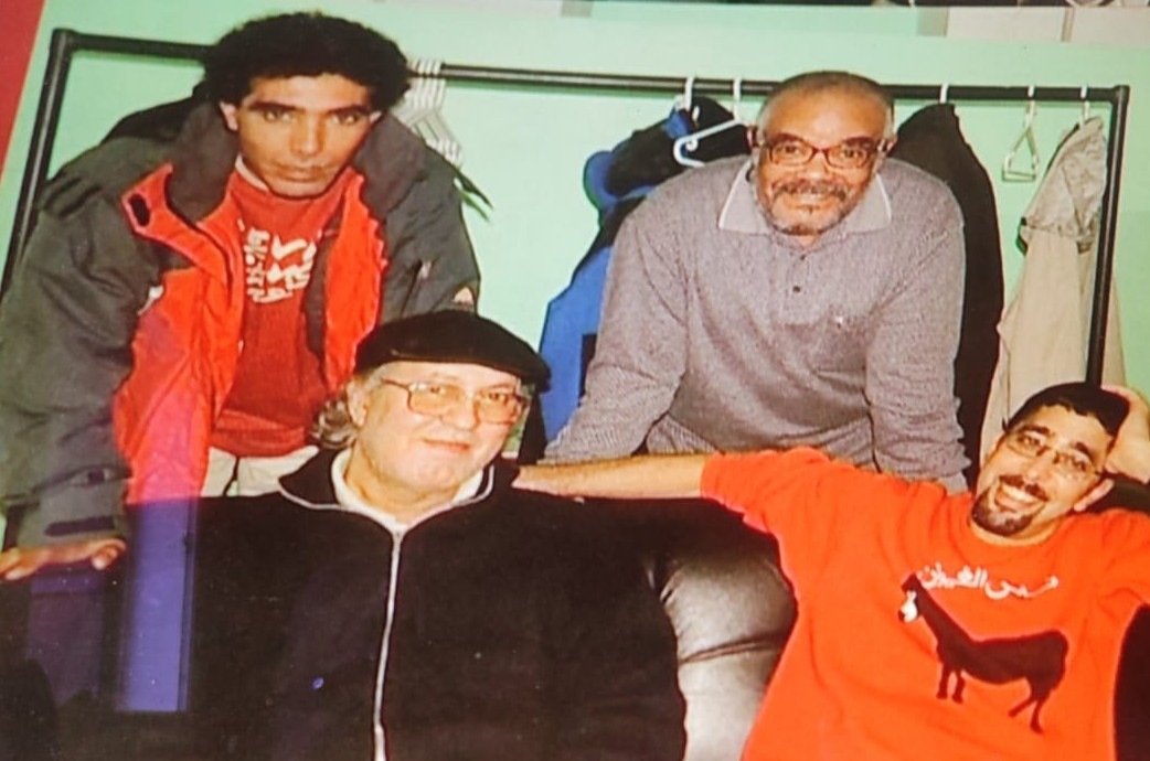 Omar Sayed with three younger friends, one wearing a Nass El Ghiwane donkey t-shirt